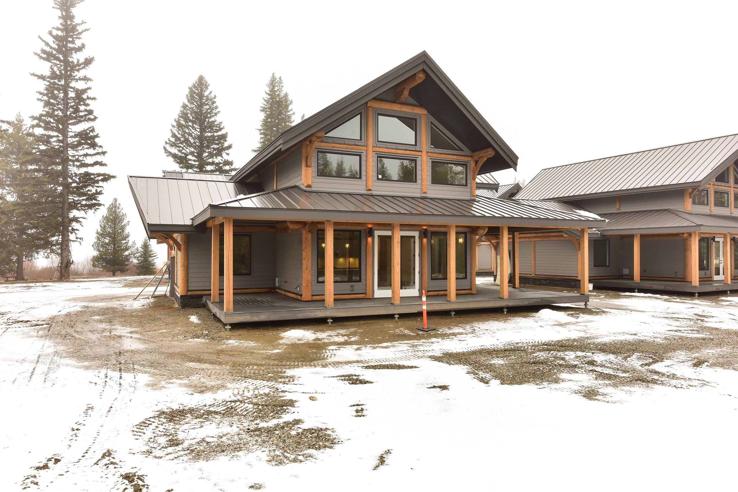 Snow-covered exterior of McCulloch Lake Cabins, a winter cabin rental near Kelowna and Big White.