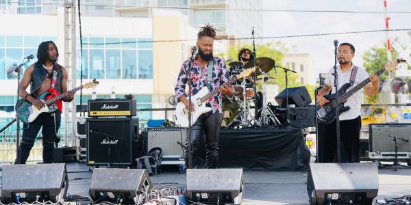 Band performing live on an outdoor stage.