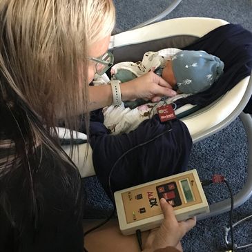 Certified nurse midwife hearing screening baby at home.