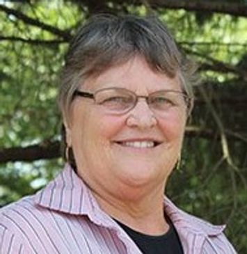 Headshot of Linda Witmer. Caucasian female with short, straight grey hair and glasses.