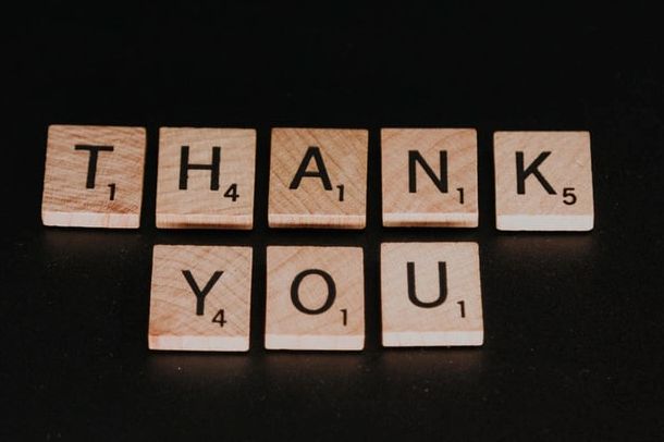 Wood Scrabble letters spelling out the words Thank You.