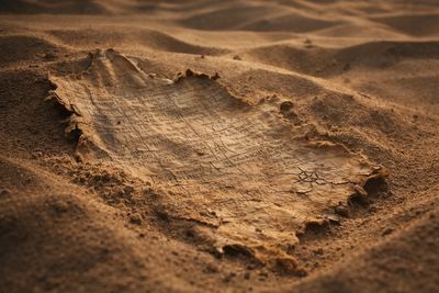 Ancient inscribed fragment buried in the desert of Zulmar, relic from the Cronux universe.