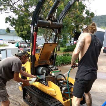mechanics working on excavator