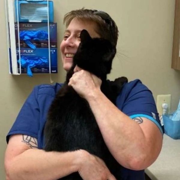 Woman holding a black cat