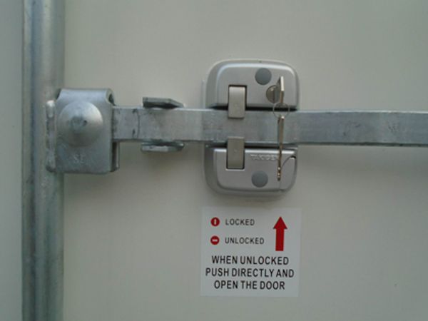 Easy open door latch with internal safety release on a portable cold storage unit