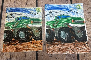 Two green monster truck drawings, one on a puzzle and one on paper.