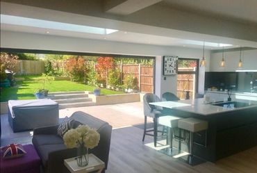 Open-plan kitchen and large rear extension with bifold doors in Essex home.