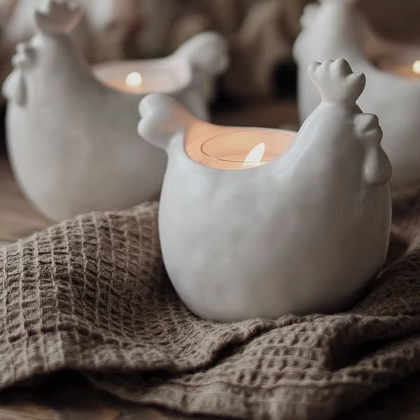 Farmhouse ceramic chicken candle decor on linen cloth — rustic lifestyle Jupiter FL