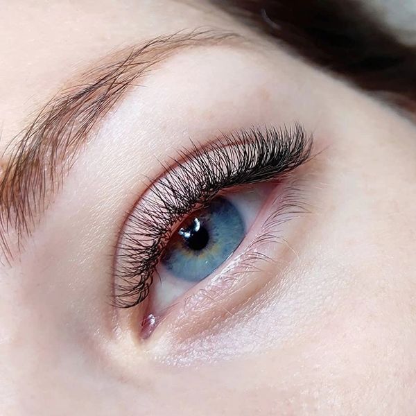 Classic eyelash extensions on a blue eye — soft, natural lashes by a lash studio in Jupiter, FL.