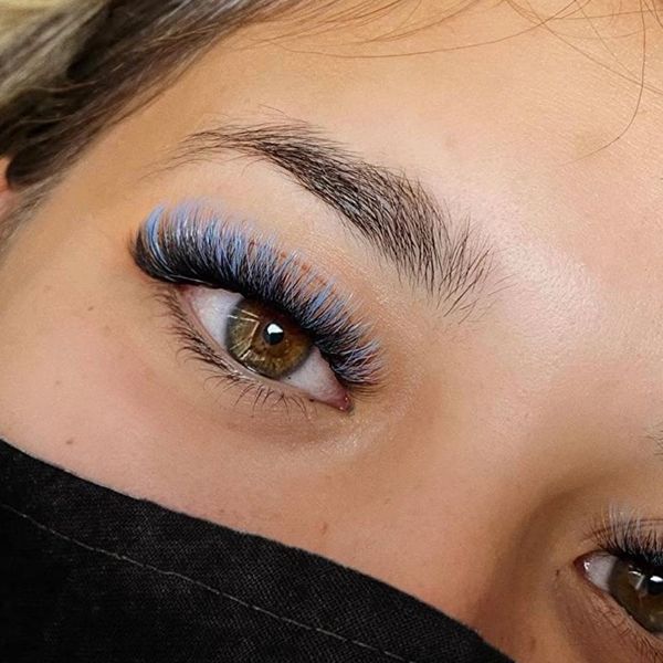 Close-up of brown eyes with volume lash extensions and mermaid lashes at a Jupiter, FL lash studio.