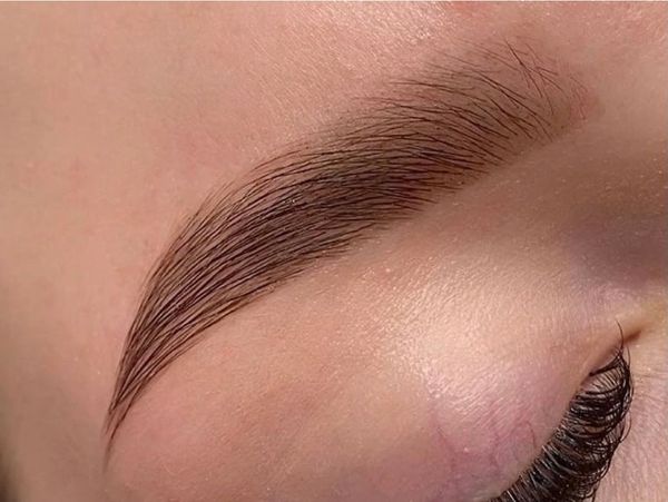 Brow tint on brown eyes — defined, natural brows at a Jupiter, FL brow studio.