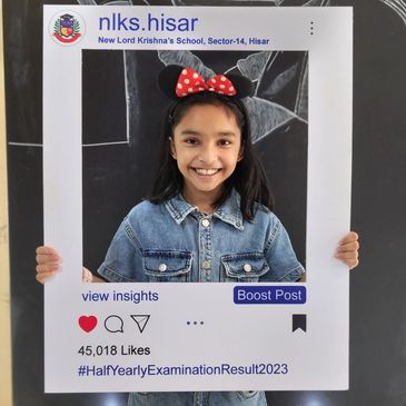 Young girl smiling inside a social media frame from New Lord Krishna's School.