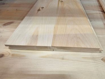 Close-up of two wooden planks with a tongue and groove joint.