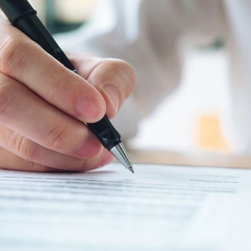 A person signing a mortgage document