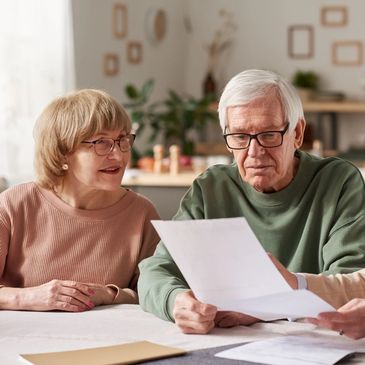 A retired couple in an equity release / lifetime mortgages meeting