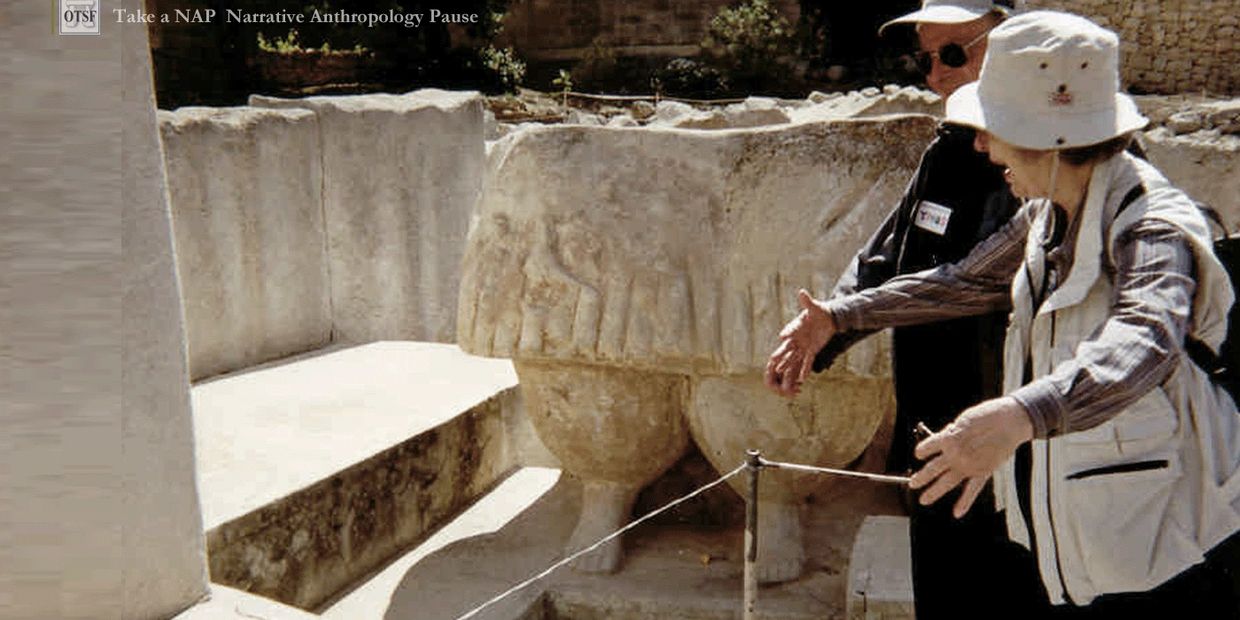 Two people examining an ancient stone artifact.