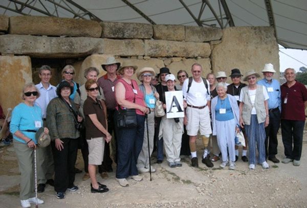 A group of people visit ancient stone sculptures