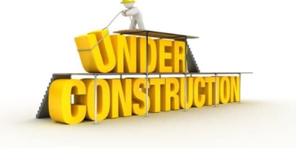 3D text 'UNDER CONSTRUCTION' with a figure building it on scaffolding.