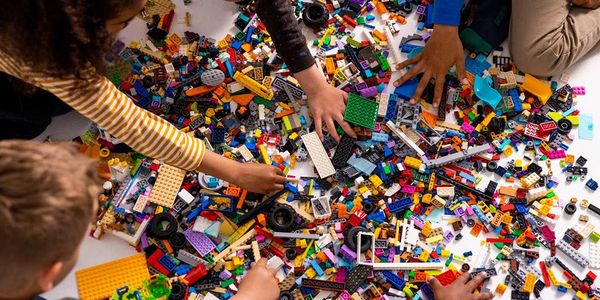 Niños jugando con piezas de LEGO.