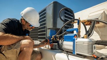 A MAN WORKING ON A HVAC