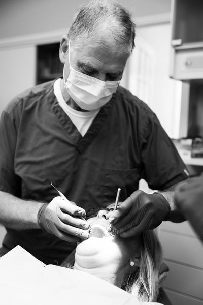 Dentist examining a patient's teeth.