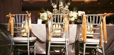 Wedding table scape and ribbon decorated chairs 