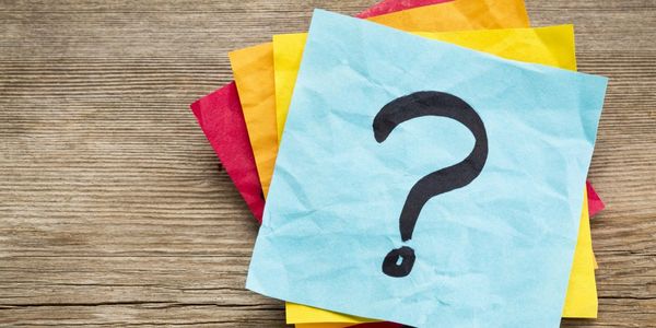 Crumpled sticky notes with a question mark on top.