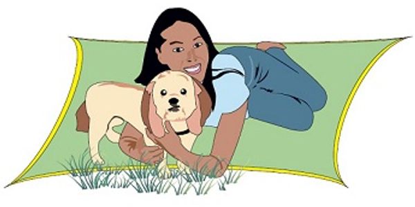 A girl lying on a green mat hugging a dog outdoors.