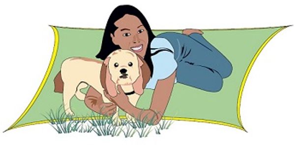 A girl lying on a green mat hugging a dog outdoors.