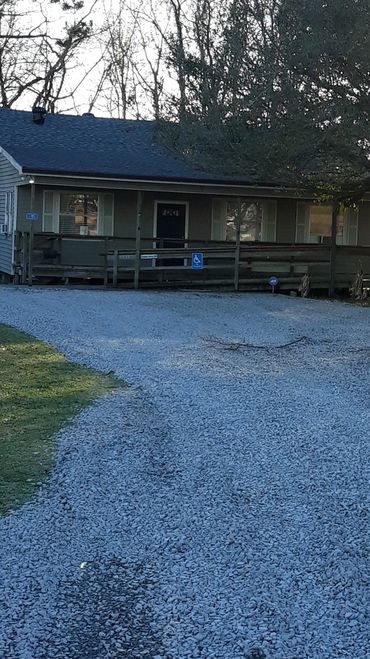 A path filled with concrete going towards a house