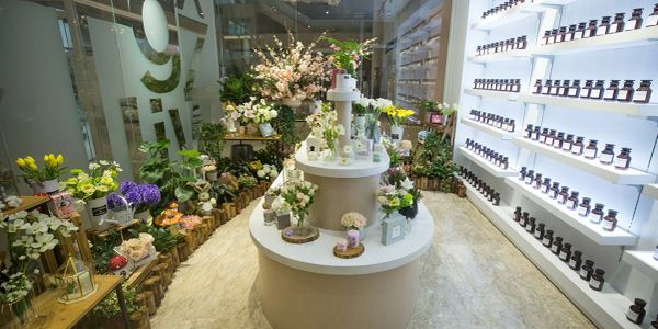Elegant flower shop interior with diverse blooms and skincare products.