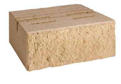 A beige rectangular brick with grooves on top.