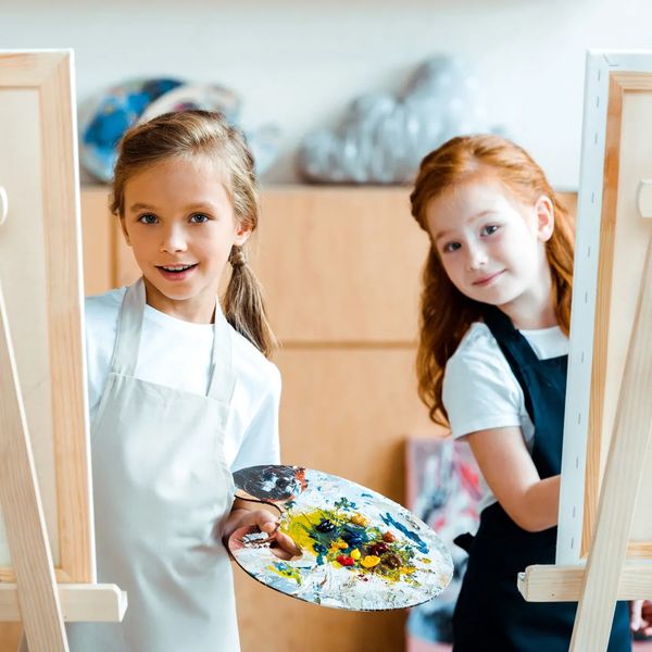 Child experimenting with mixed media art in kids’ class in Tucson area.