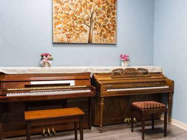 Music instruction room with acoustic piano and early childhood learning environment.