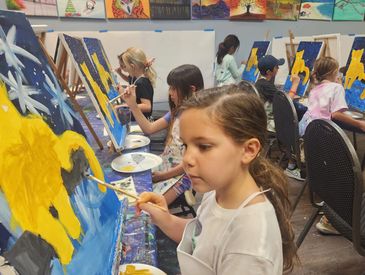Kids painting and drawing during summer art camp in Tucson area.