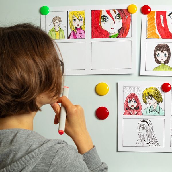 Teen working on manga project during art lessons at Artistry Academy.