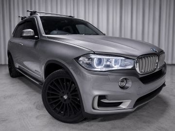Gray BMW SUV in a showroom.