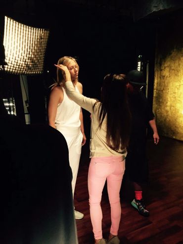 Vita Krafty adjusting hair for model on set