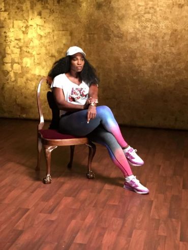 Serena Williams sitting on a chair in sportswear