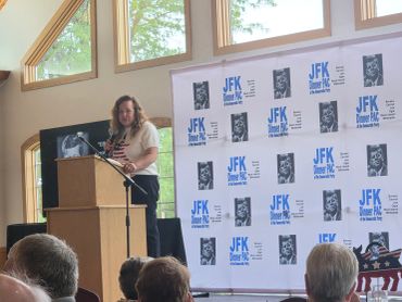 Nicole Dopler Candidate for IL 73, at JFK Dinner PAC event with audience.