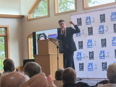Candidate for Illinois D16 Paul Nolley passionately addressing an audience at JFK Dinner PAC event.