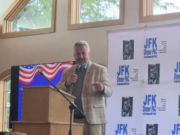 Congressman Eric Sorensen speaking at a JFK Dinner PAC event.