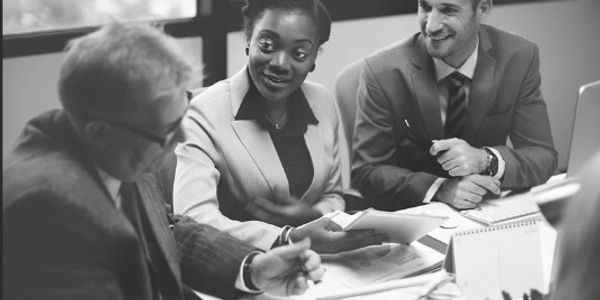 Three professionals engaged in a lively business meeting.