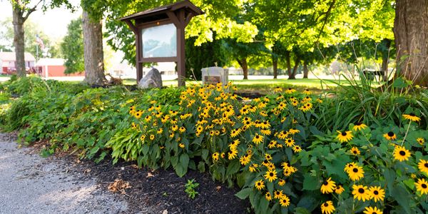 Flowers and a community sign at Hardin Park for the Shelby County Parks District.
