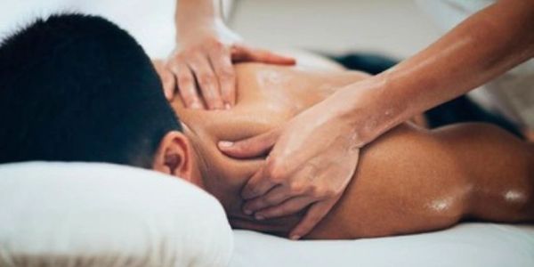 Person receiving a relaxing shoulder and back massage.
