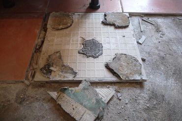 Five spots bonding tile installation failure, showcasing bad tiling techniques and cutting corners