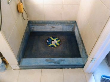 Primed shower pan prepared for the next stages of repair, showcasing a smooth surface