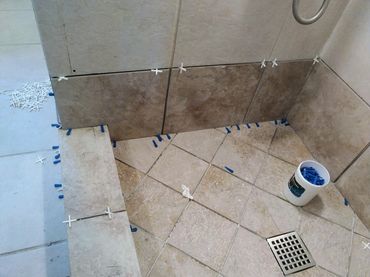 Close-up of a tiling process, showcasing tile installation, highlighting attention to detail