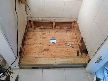 New timber floor added to the shower base highlighting the proper shower installation and repair