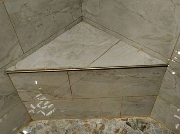 Incorrectly installed shower seat, demonstrating misalignment and potential water damage risks